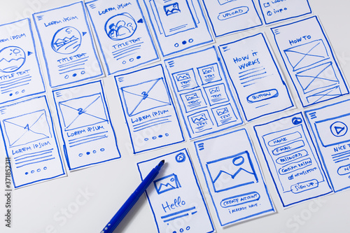 User experience design, desk with paper sketches for mobile interface