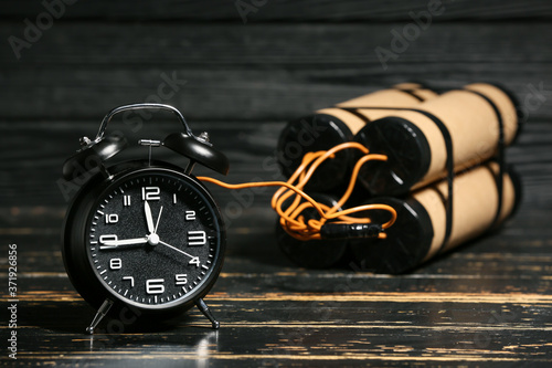 Bomb with clock timer on wooden background