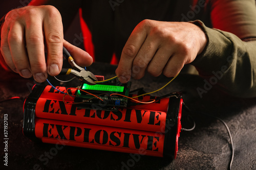 Man defusing bomb at table, closeup