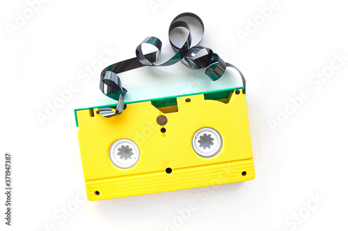 yellow videotape Isolated on white background. Creative concept in retro style, 80s. Top view, minimalism. Retro technology concept. Blank screen for text.