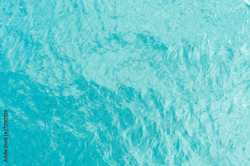 Aerial view of a crystal clear sea turquoise water texture. View from above Natural blue background. Turquoise water reflection. Blue ocean wave. Summer sea. Drone. Top view