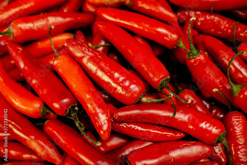 red serrano chili peppers at a market stall