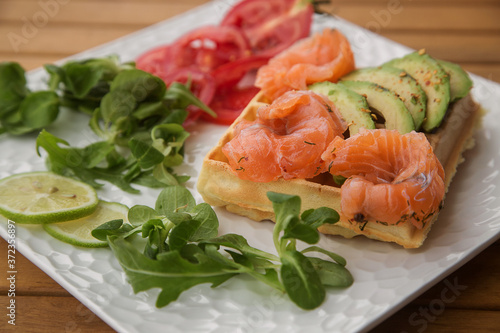 waffle with slices of salted salmon and avocado. the concept of a healthy Breakfast