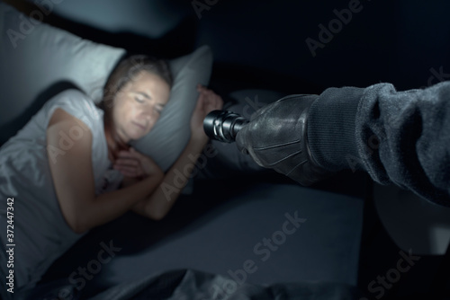 Thief threatening a woman at night