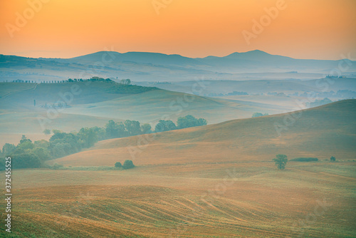 Beautiful sunrise over the Tuscany hills and fields. Travel destination Tuscany