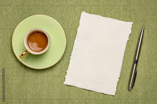 small sheet of blank white Khadi rag paper with a cup of coffee