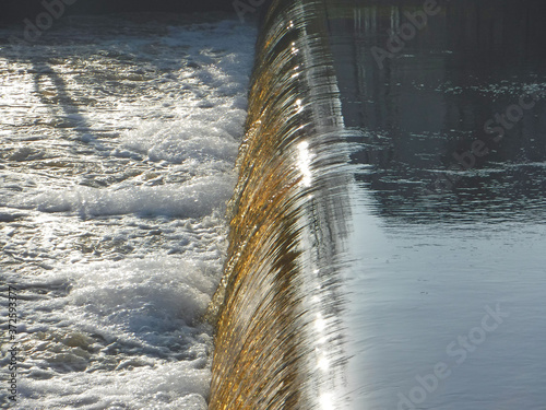 Water weir across the width of a river