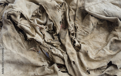 Old dirty torn rag isolated on white background. Cleaning rag.