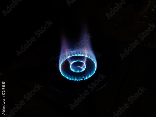 This is the bluish flame of the cooking gas close-up shot in the night.