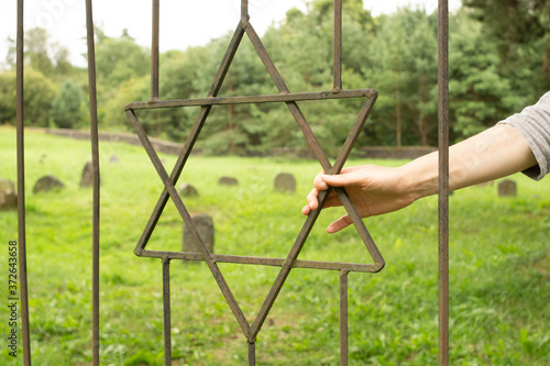 Star of David (symbol and sign of the Jews) on the iron grate of the old Jewish cemetery.