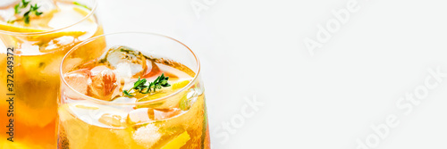 Iced tea with ice, mint and lemon. Refreshment cold summer drink. Close up shot. Banner with copy space for text.