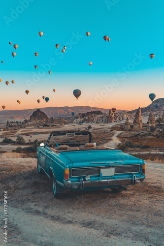 retro car on cappadocia and hot air baloons