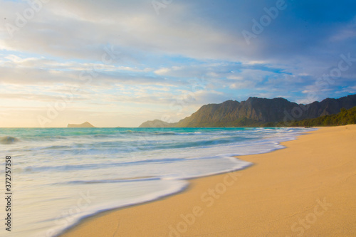 Coastline with waves at sunrise on the beach at Waimanalo on the windward side of Oahu in Hawaii