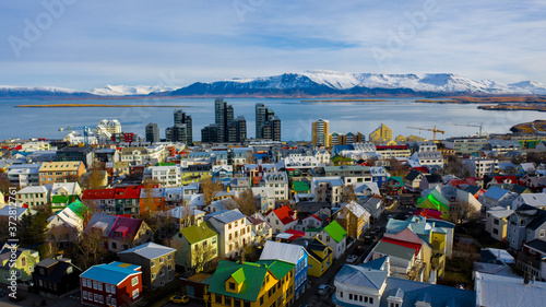 Aerial view of colorful buildings in Reykjavik Iceland with mountains and clouds in the background