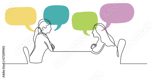 two young women sitting behind table talking with speech bubbles