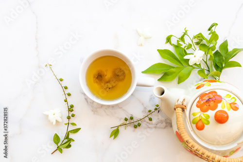herbal healthy drinks hot chrysanthemum tea local flora of asia with teapot, flower jasmine ,purple in summer season arrangement flat lay style on background white 
