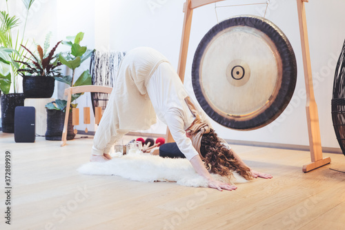 Yoga Kundalini woman downwardfacing dog gong white gong bath adomuka savasana music sound