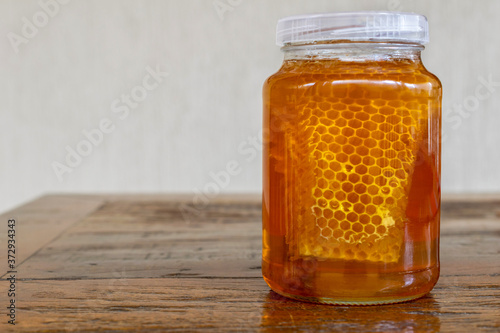 glass with honeycomb on rustic table