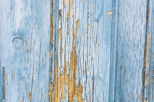Detail of the texture of a vintage blue worn wood door