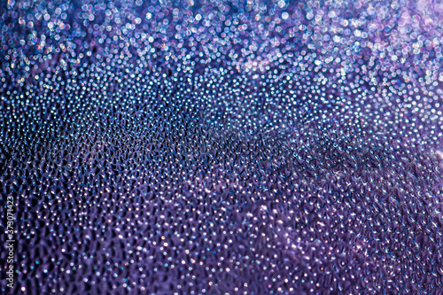 Blue and purple water drops on the glass, abstract background, large and small drops. Space for text