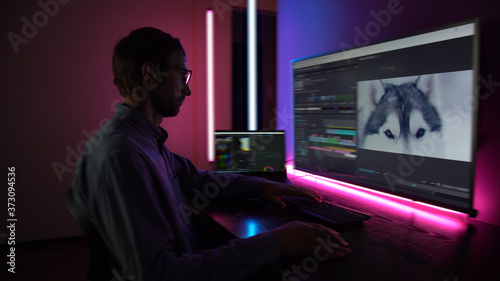 The man makes video editing. Video production. Color Correction. Sound editing. Film making. The work of a freelancer. Equipment filmmaking. Create videos. Program for video editing. 