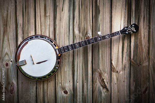 5 String Banjo on a brown rustic natural wood background 