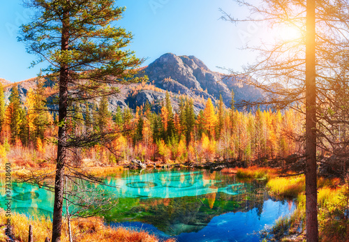 Geyser lake with turquoise water in Altai mountains, Siberia, Russia. Autumn nature landscape. Famous travel destination