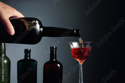 Aged golden fortified sherry being poured into a crystal glass.