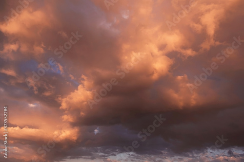 Epic dramatic sunset, sunrise storm sky with dark orange yellow clouds and sunlight, heaven