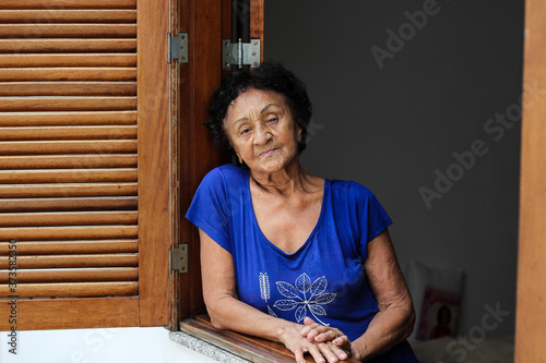 Portrait brazilian mature woman at window