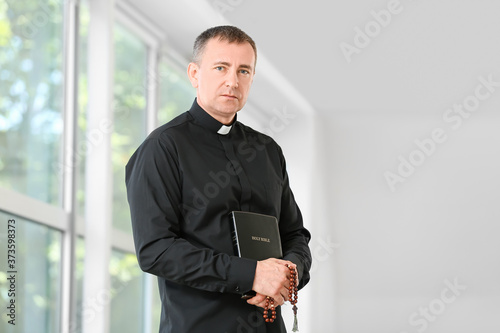 Portrait of male priest at home