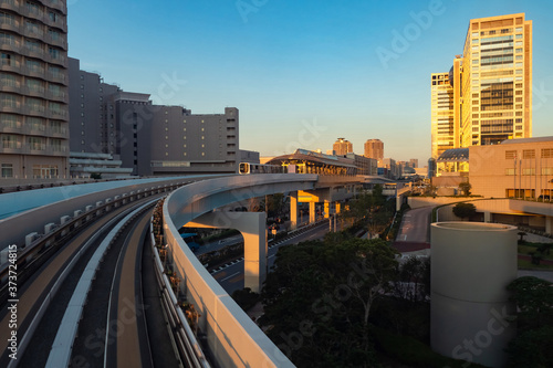 Japan. City landscape at sunset. Railway transport in Tokyo. The train goes through the Central part of Tokyo. Transportation of passengers in the Japanese capital. Railway in Tokyo.