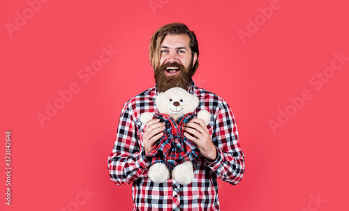 Romantic greeting. Man with beard hold cute toy bear. Man holds teddy bear. Gifts and holidays concept. This is for you. hipster like animal toy. Birthday holiday party celebration. feel happiness