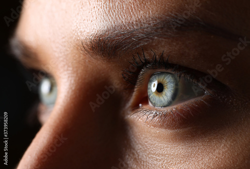 Amazing female green colored eyes in low light technique