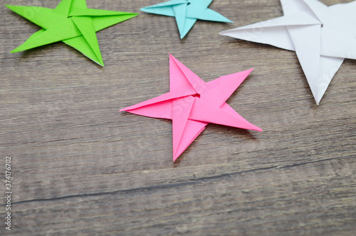 holiday paper stars on wooden background