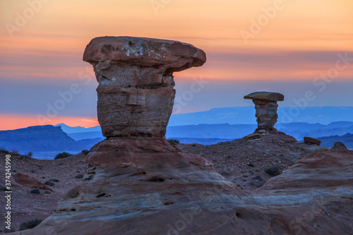 Two similar hoodoos sit opposite at sunset near the San Rafael Reef in Utah.