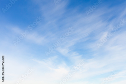 Blue sky with blurred windy clouds at daytime
