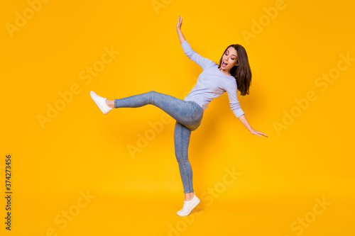 Full length body size view of her she nice attractive pretty funky clumsy slender cheerful cheery girl jumping having fun fooling isolated bright vivid shine vibrant yellow color background