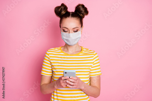 Close-up portrait of her she nice attractive pretty focused girl wearing safety mask using gadget app 5g shopping order stay home keep social distance mers cov isolated pastel pink color background