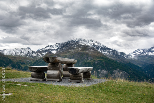 View of a bench with Austrian mountains in background.