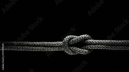 Reef knot black rope on a black background.