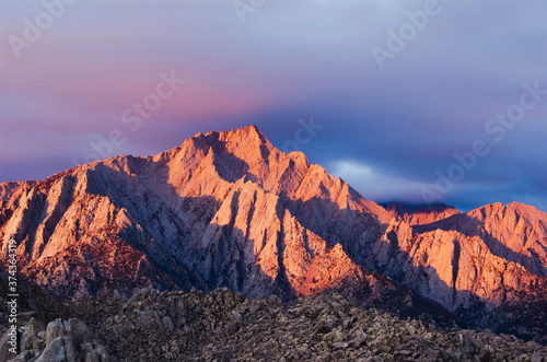 Good morning Mount Whitney landscape, with some heavy clouds moving out. This scenic image is of the largest peak in the lower 48 US states. rich with sunrise color and texture of mountains ranges.