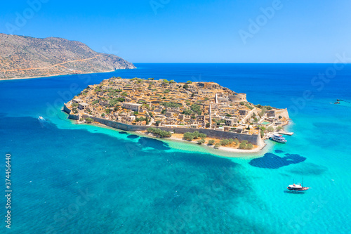 View of the island of Spinalonga with calm sea. Here were isolated lepers, humans with the Hansen's desease, gulf of Elounda, Crete, Greece. 