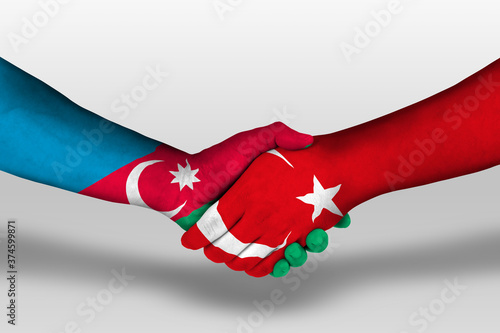 Handshake between turkey and azerbaijan flags painted on hands, illustration with clipping path.