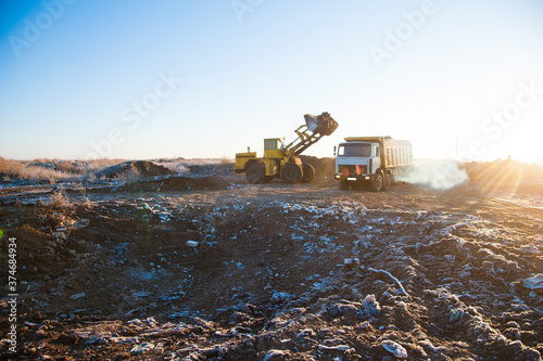 Bulldozer removes a wild dump