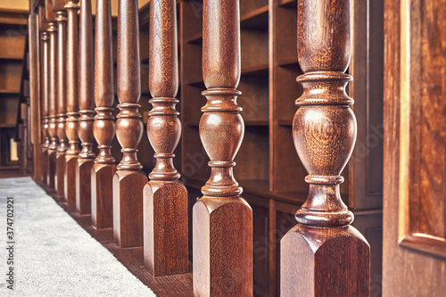 Wooden balustrade of classic staircase in modern house. Close-up