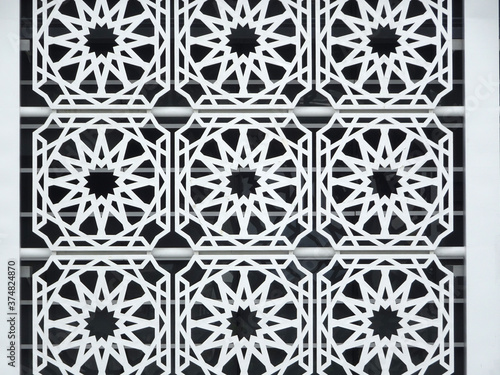 Islamic geometry pattern made from metals and ground fibre reinforcement concrete used as building facade as wall decoration. 