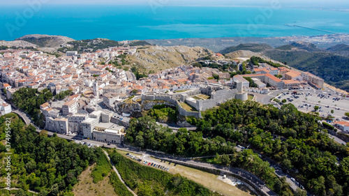 Aerial view of the castle of Monte Sant'Angelo on the Gargano peninsula in Italy, photographed from a drone in flight - Medieval stronghold and Christian Sanctuary on a hilltop over the Adriatic Sea