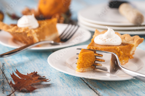 Cutting into a slice of pumpkin pie