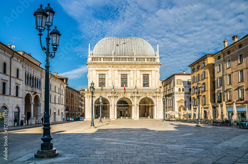 Palazzo della Loggia palace Town Hall Renaissance style building and street lights in Piazza della Loggia Square, Brescia city historical centre, blue sky background, Lombardy, Northern Italy